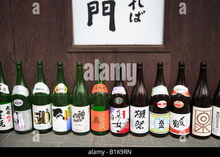 Sake bottles on display outside restaurant in Tokyo Japan Stock Photo