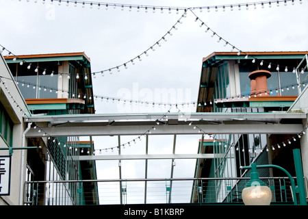 Strings of patterned lights hanging from two buildings Stock Photo