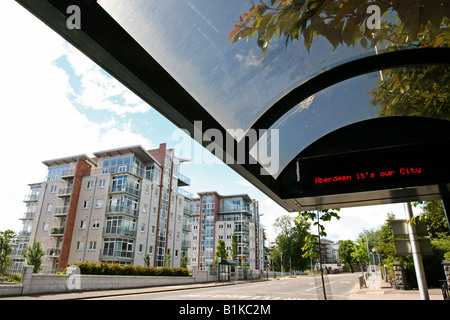 Modern bus shelter with led readout near new flats and apartment blocks on Queens Road in the city of Aberdeen, Scotland, Uk Stock Photo