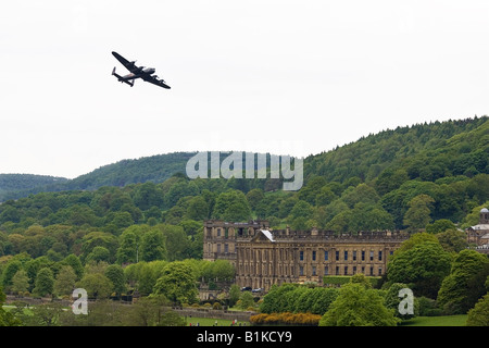 A Lancaster RAF Bomber makes a flypast over Chatsworth House home to the Duke of Devonshire Stock Photo