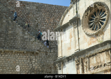 Holidaymakers walk up to the city walls by St Saviour's Church, Dubrovnik, Croatia Stock Photo