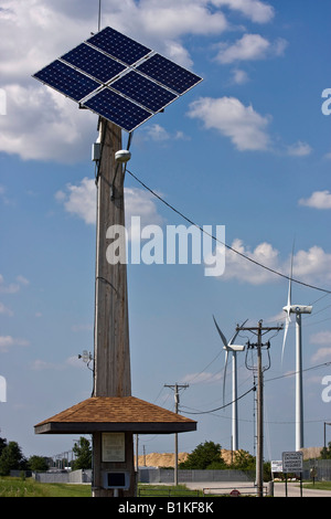 A single solar panel with the wind turbines on a field pictures images photos very high resolution low angle close up vertical format in USA US hi-res Stock Photo