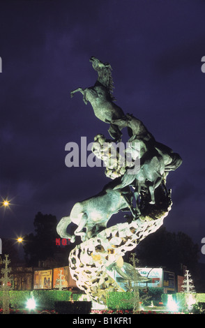 Los Caballos /  The Horses metal horse sculpture by Juan José Oliveira in Plaza España at twilight, Vigo, Galicia, Spain Stock Photo