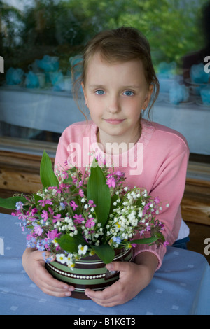 The girl, eight years, with a bouquet of flowers. Stock Photo