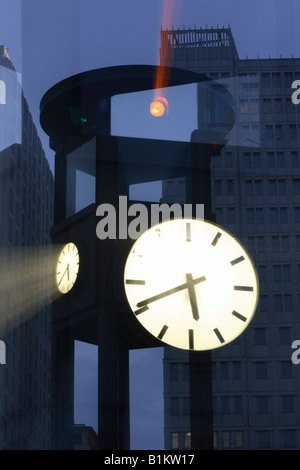 Illuminated clock and office buildings at the Potsdam Square, Berlin, Germany Stock Photo