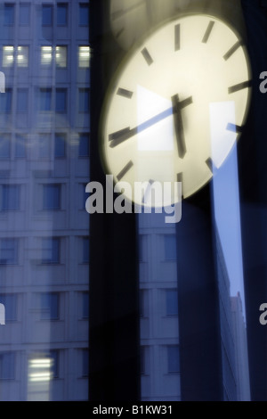Illuminated clock and office buildings at the Potsdam Square, Berlin, Germany Stock Photo