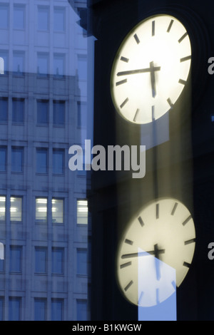 Illuminated clock and office buildings at the Potsdam Square, Berlin, Germany Stock Photo