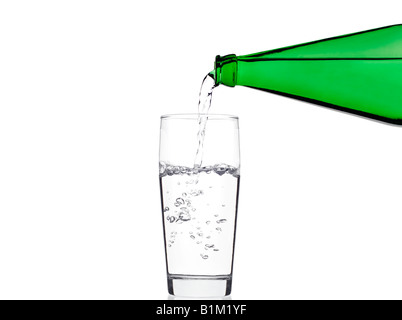 Pouring Water into a Glass Against a White Background Stock Photo