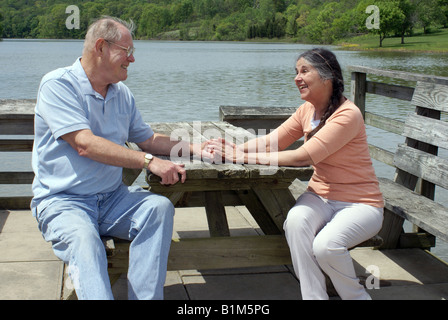 Couple Sitting By a Lake Stock Photo
