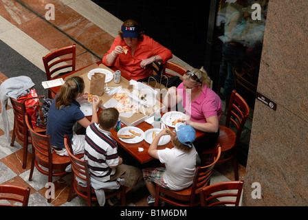 A family of tourists eats a lunch of gourmet pizza at the Donal Sacks restaurant Stock Photo