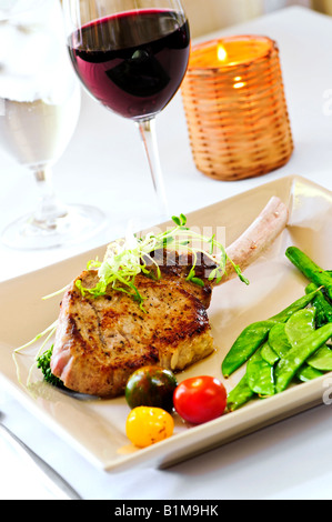 Gourmet dinner of veal rib chop and vegetables Stock Photo