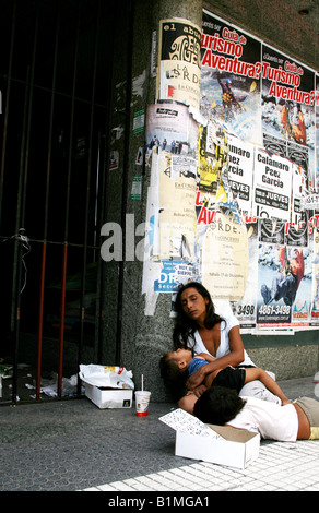 Woman begs with her children on a street in Buenos Aires, Argentina Stock Photo