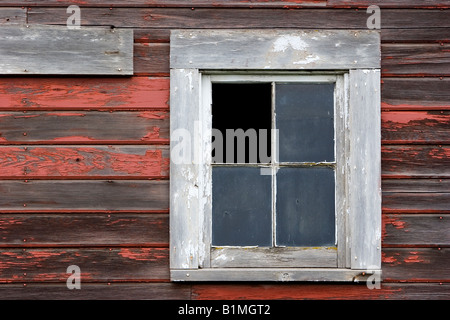 A broken window in the side of an old barn on the Old Moscow Highway in the Palouse area of Washington USA Stock Photo