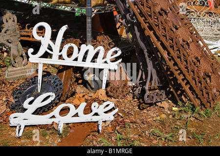 Metal garden decorations of words Love and Home next to rusted metal objects Stock Photo