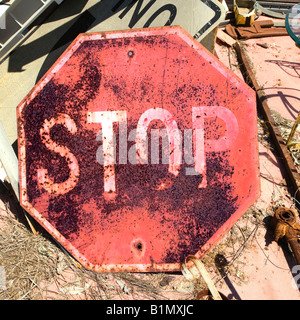 Rusty old stop sign on ground Stock Photo