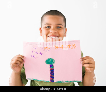 Young boy proudly showing drawing Stock Photo