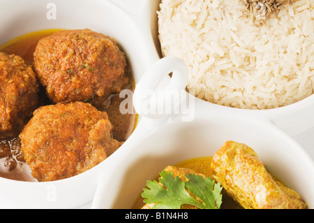 Close-up of koftas curry and boiled rice and meatballs in bowls Stock Photo