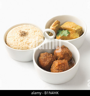 Close-up of boiled rice and meatballs with fish curry served in bowls Stock Photo