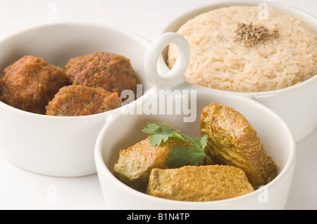 Close-up of boiled rice and meatballs with fish curry served in bowls Stock Photo