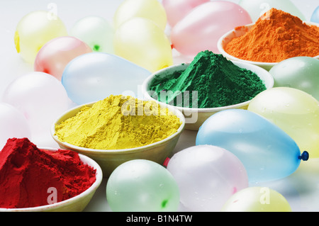 Close-up of water bombs and bowls of powder paint Stock Photo