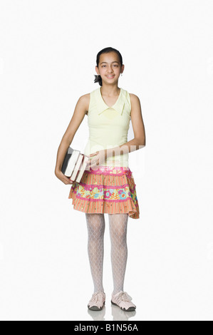 Portrait of a girl holding books and smiling Stock Photo - Alamy