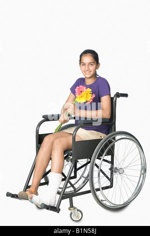 Portrait of a teenage girl sitting in a wheelchair and smiling Stock Photo