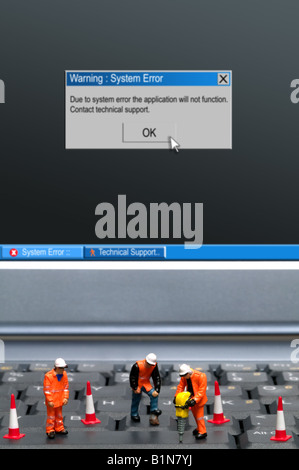 Miniature workmen repairing a computer keyboard system error message on the screen part of a series of images along this theme Stock Photo