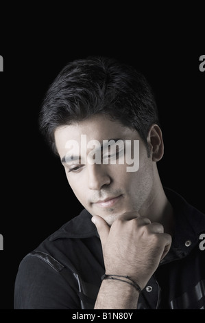 Close-up of a young man thinking Stock Photo