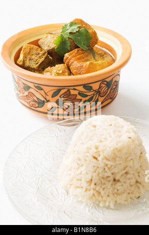 Close-up of boiled rice served with fish curry in a bowl Stock Photo