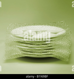 Close-up of a stack of plates wrapped in a bubble wrap Stock Photo