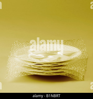 Close-up of a stack of five plates wrapped in a bubble wrap Stock Photo