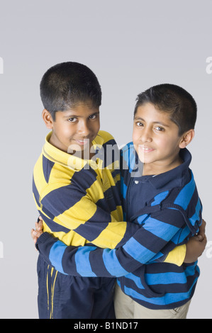 Portrait of two boys hugging each other Stock Photo