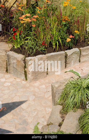 paved path with raised flower beds for easy access Stock Photo