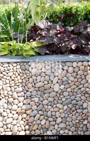 garden wall made of pebbles and slate Stock Photo
