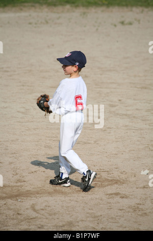 An eight year old boy is pitching at a Little League baseball game in Londonderry, New Hampshire. Stock Photo