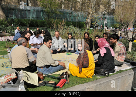 Iranians flock outdoors to celebrate ancient festival marking end of Persian New Year holidays.Families gather in Tehrans Niavar Stock Photo