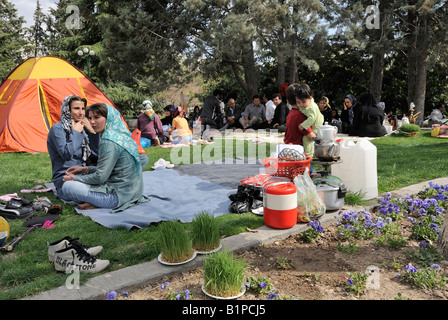 Iranians flock outdoors to celebrate ancient festival marking end of Persian New Year holidays.Families gather in Tehrans Niavar Stock Photo