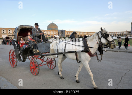 Popular horse and carriage rides taking vistors around Khomeini, Square Esfahan. Stock Photo