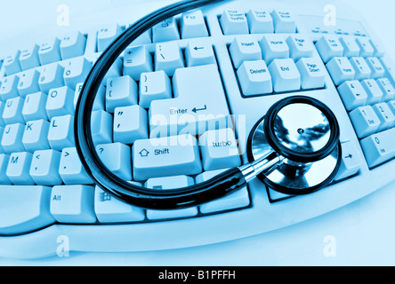 medical technology or computer problems stethoscope and keyboard on clinical blue Stock Photo