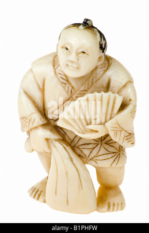 Netsuke man with a sack and fan Stock Photo