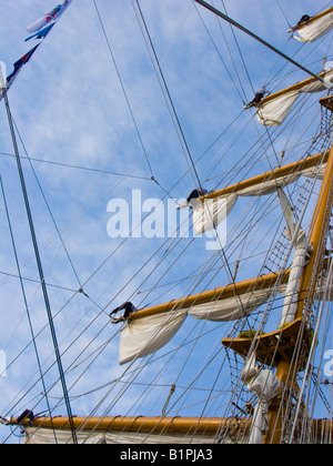 Sailors prepare to release sails from the yard arms of the Mexican sail training vessel ARM Cuauhtémoc. Stock Photo