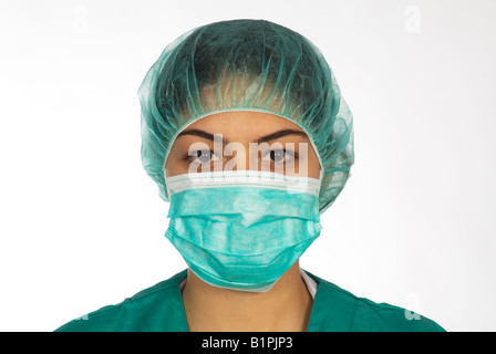 Portrait of a woman nurse in green scrubs uniform and mask looking at camera Stock Photo