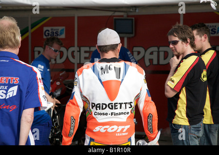 John McGuinness chats to his pit crew prior to a practice session for the 2008 Isle of Man TT races. Stock Photo