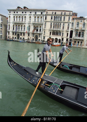 two gondoliers rowing in venice italy Stock Photo