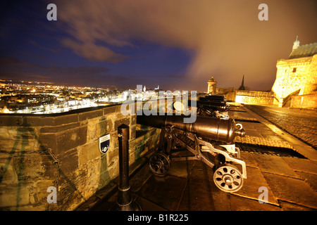 City of Edinburgh, Scotland. Night floodlit view of the Argyll Battery cannons in the Middle Ward of Edinburgh Castle. Stock Photo