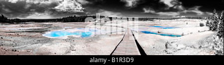 Panorama image looking down and following the long winding wooden boardwalk trail that wanders through the pools of the Norris G Stock Photo