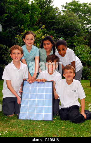 Primary school pupils delight in having solar panels installed at their school, All Saints Primary School, Fulham, London, UK. Stock Photo