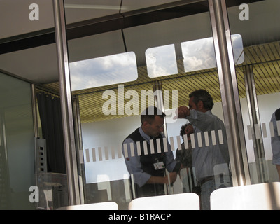 Passengers being checked up by security man in Berlin International Airport Germany Stock Photo