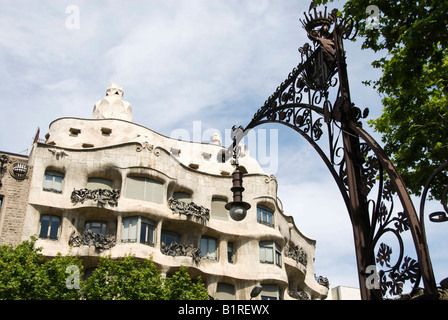 Facade of the Casa Milà, also known as La Pedrera or The Quarry, designed by the architect Antoni Gaudí, behind a street lamp d Stock Photo