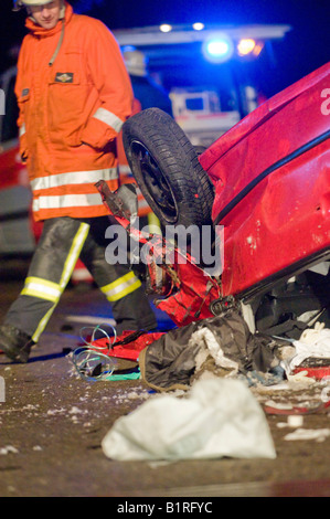 Fireman at the wreck of a rolled over small car after an accident on the A8 near Neuhausen, Denkendorf, Esslingen Region, Baden Stock Photo